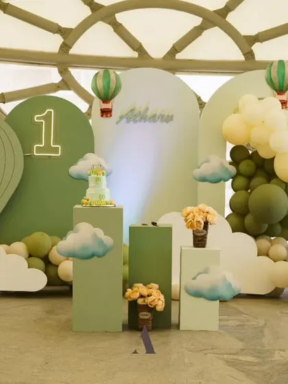A sage green hot air balloon theme. This beautiful, modern color palette gives a fresh and adventurous feel to the celebration.