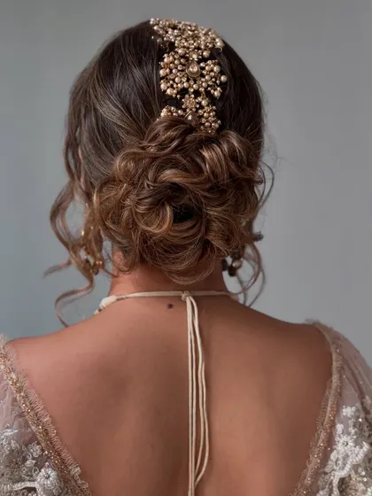 The back view of a messy updo, showcasing the intricate placement of the hair accessory.