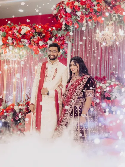 A fairytale moment for the couple. Standing amidst a cloud of low fog and a shower of cold sparks, the bride and groom looked absolutely radiant on their beautifully decorated reception stage.