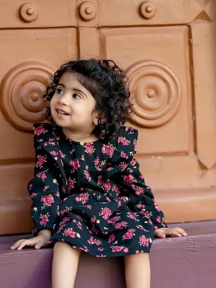 A sweet moment of a little girl sitting in front of a rustic door in our garden. The textures and colors create a beautiful backdrop.