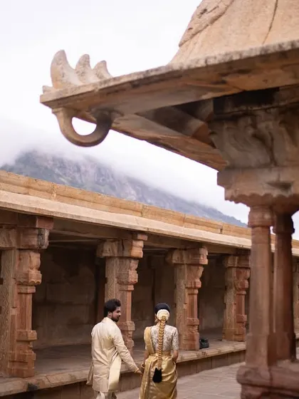 Another perspective of their walk through the temple corridors. This angle highlights the unique architectural details and the vastness of the historical site.