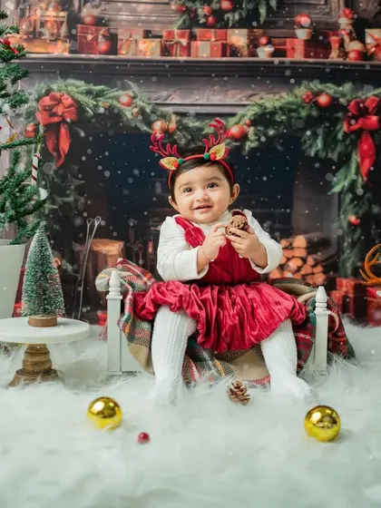 Adding a touch of fun with reindeer antlers. This little girl is enjoying the festive props.