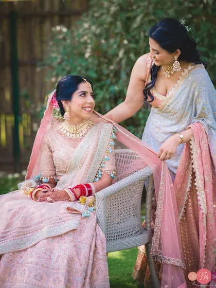 A sweet moment between the bride and her sister or friend during the getting-ready process.