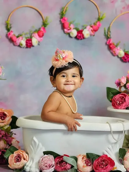 A beautiful bath time photo surrounded by pink flowers. This sitter session combines a classic tub shot with a lovely floral theme.