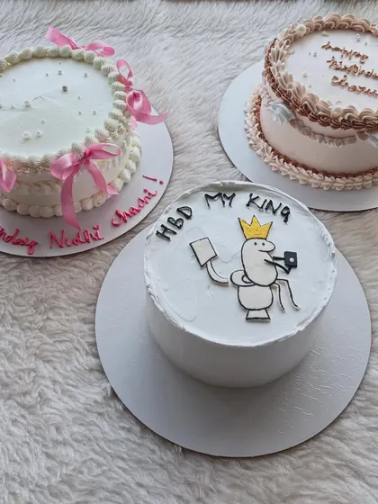 This was for a party with three different celebrations. I made three unique cakes: a fun cartoon cake, an elegant ribbon cake, and a classic piped border cake.