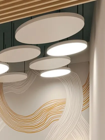 A detail of the custom wall mural and suspended lighting panels in the waiting area. The organic, flowing lines of the mural add a soft, artistic touch to the corporate space.