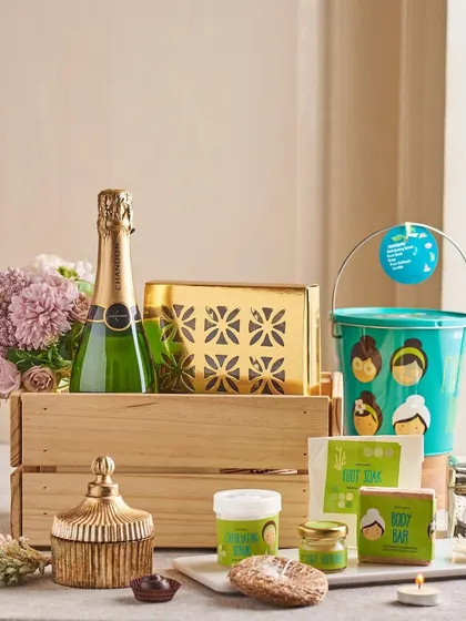 A luxurious spa and celebration hamper for the couple. This wooden crate contains a bottle of champagne, a full spa kit, and other decorative items for a truly indulgent experience.