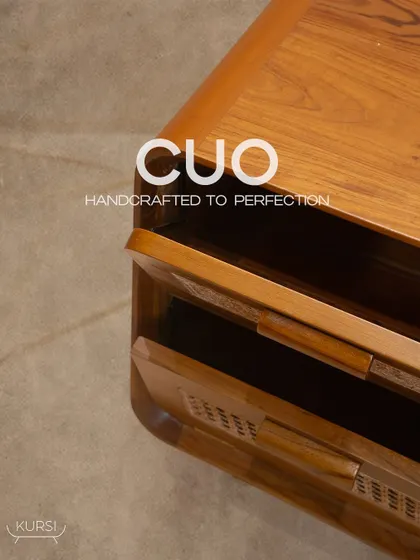 A top-down view of the 'Cuo' side table, showing the rich grain of the teak wood and the elegant, curved silhouette. Handcrafted to perfection.