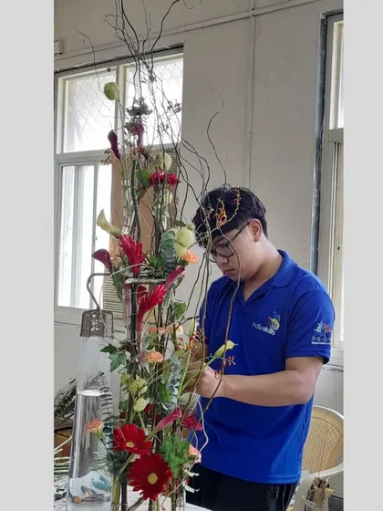 Maximus, our WorldSkills competitor, is seen here perfecting a large, complex arrangement during his intensive training at our institute. We prepare our students for the highest levels of competition.