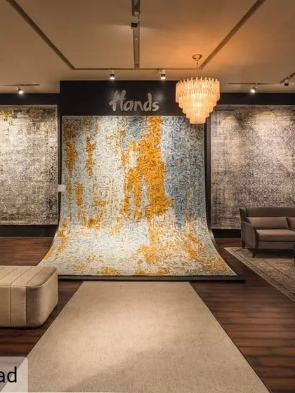At the Hands Carpets exhibition, we designed the space to let the product be the hero. A dramatic, oversized carpet cascades from the wall to the floor, creating a powerful focal point that immediately communicates the brand's artistry and quality.
