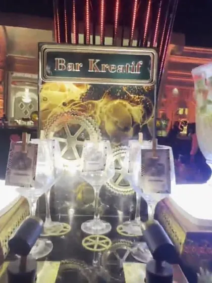 The 'Bar Kreatif' station, where I offer unique and creative beverage options. The presentation includes a large glass dispenser with infused water or sangria.