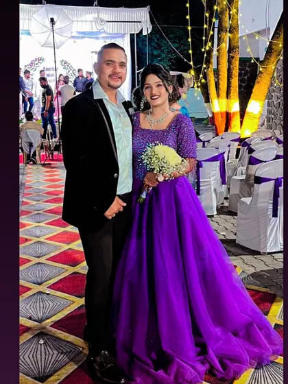 A beautiful couple portrait from their celebration. The bride looks radiant in this vibrant purple ball gown, a perfect choice for an engagement or reception.