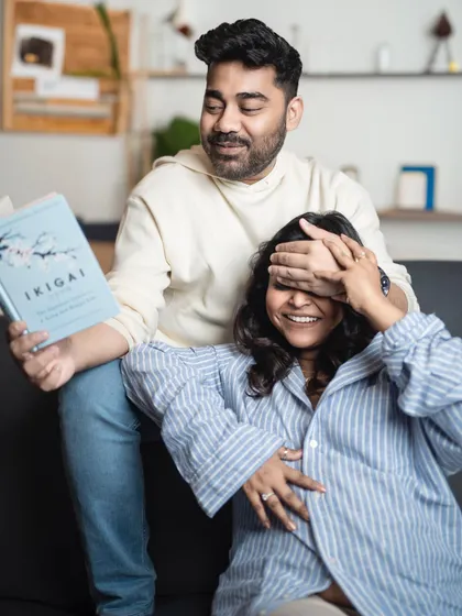 A playful moment during a casual maternity session. Reading and laughing together, this couple's joy is infectious.