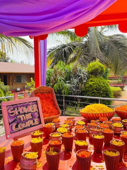 A "Shower the Couple" station with terracotta cups filled with flower petals.