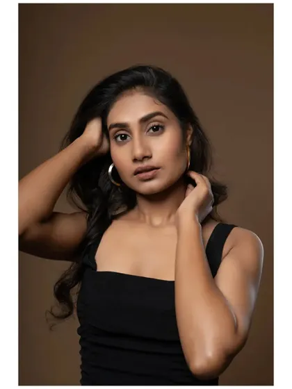 A classic headshot from a model portfolio session. The focus is entirely on the model's face and expression, with soft lighting to create a clean and professional look.