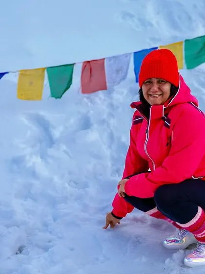 A happy moment in the snow. A participant enjoys the cold, crisp air at one of the highest motorable passes in the world.