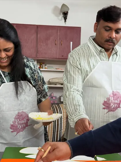 A smiling couple at a collaborative painting session. The joy and connection are what make these events so special.