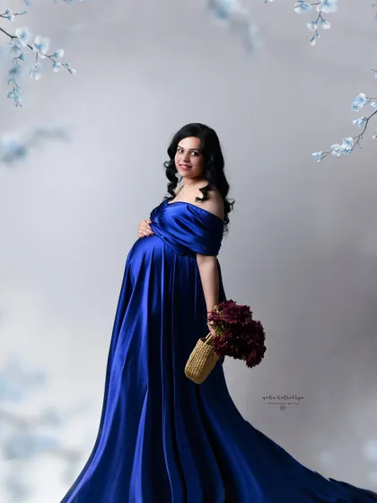 Adding simple props like a basket of flowers can bring a soft, personal touch to a classic studio portrait.