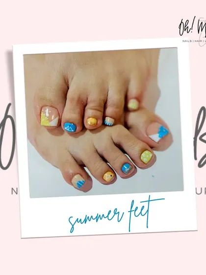 Get your feet summer ready with our creative pedicure nail art. This photo shows a playful design with bright yellow and blue polish, perfect for a beach vacation or just to add a pop of color. We make sure your toes look as good as your hands.