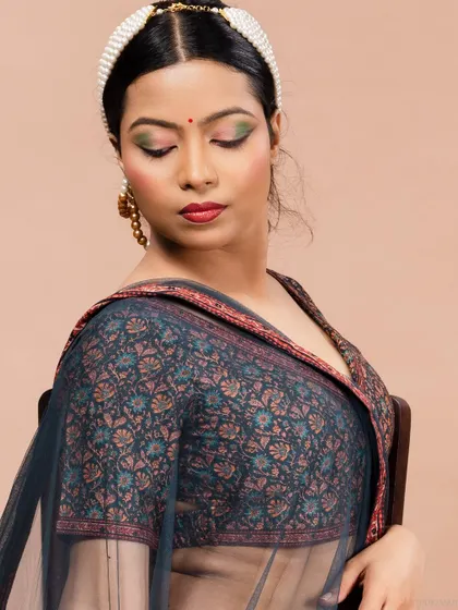 An intimate close-up of the model in a lehenga, highlighting the details of the blouse and makeup.
