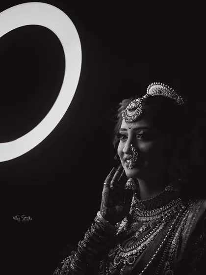 A beautiful black and white portrait where the ring light creates a halo effect. The bride's expression is soft and thoughtful, resulting in a timeless and artistic photograph.