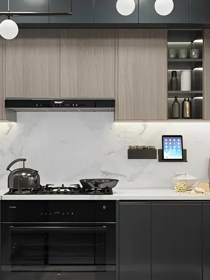 A modern kitchen with grey and wood-finish cabinets and a white marble backsplash. The layout includes built-in appliances and smart storage solutions for a functional and stylish cooking area.