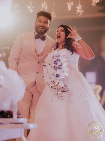 The couple celebrating at their beach wedding reception, full of joy and energy.