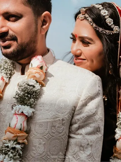 A quiet, romantic moment between a couple on their wedding day. The bride's loving gaze speaks volumes, capturing the deep connection they share.