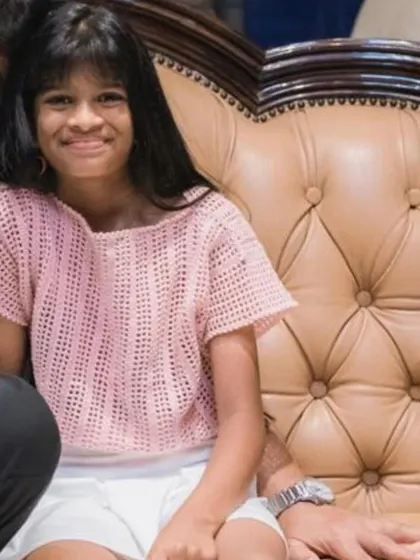 A sweet client wearing her light pink crochet top. The open stitchwork makes it lightweight and perfect for warmer weather, and the simple design is comfortable for play.