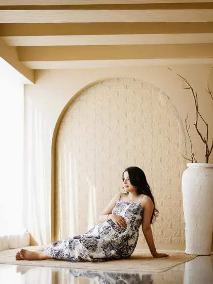 A peaceful solo portrait of the mother-to-be relaxing in our earthy, minimalist studio setup.
