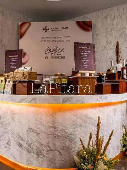 The main coffee bar, built with a sleek marble-finish counter and warm under-lighting. We set up a full coffee tasting experience here, complete with various blends and informational signage.