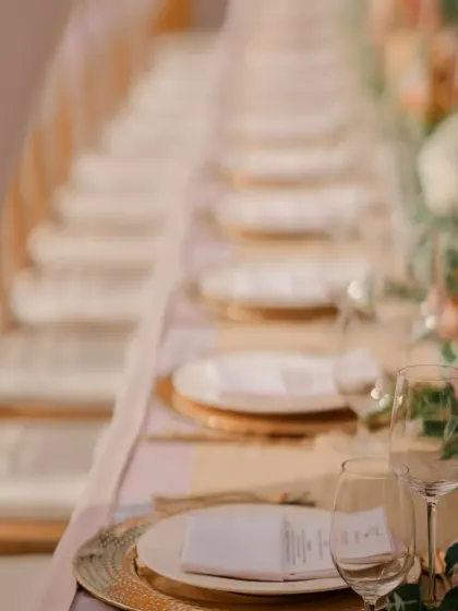 A long shot of the beautifully arranged dining table for an intimate wedding, ready to welcome guests for a celebratory meal.