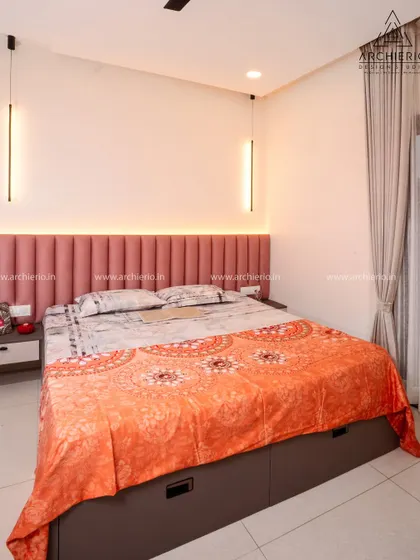 This bedroom features a striking fluted pink headboard with integrated backlighting, creating a modern and cozy ambiance.