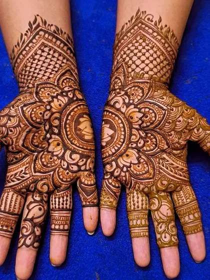 A mandala design that incorporates a groom's portrait right in the center of the palm, surrounded by floral and geometric patterns.