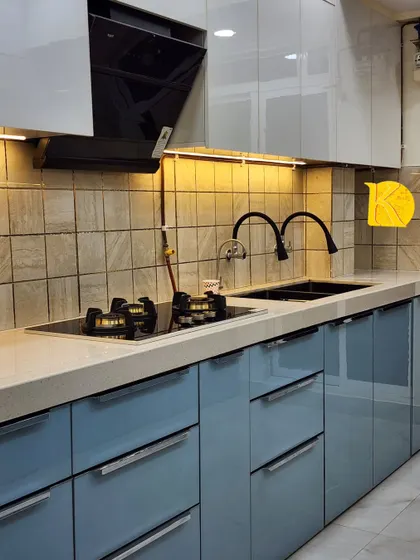 A close-up of the dual-burner hob and double sink, showcasing the quality of fittings we use in our kitchen projects.