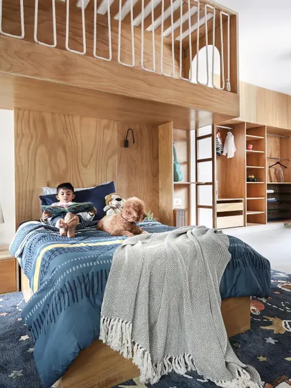 A child's room should be a world of its own. For this space, we designed a custom double-decker bed from exposed birch plywood, creating a playful yet timeless "treehouse" where imagination can take flight.