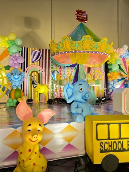 A close-up of the character props on the carnival stage, including Dumbo, a pig, and a clown.