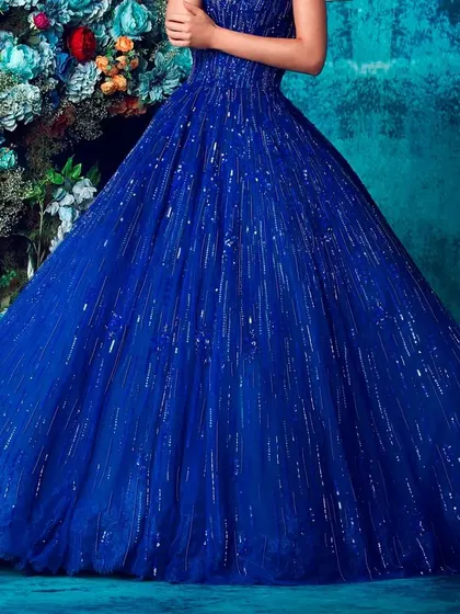 A close up detail of the sparkling fabric of our blue ball gown. The glitter effect catches the light for a dazzling look.
