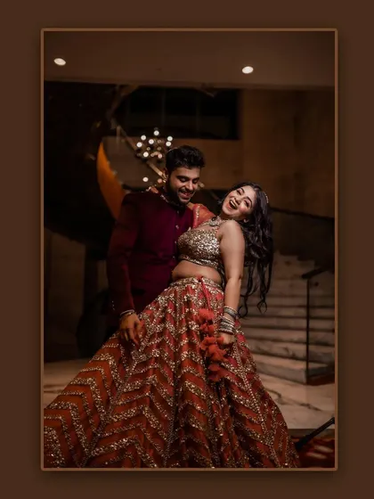 A joyful and dynamic shot from their Roka ceremony. The groom has his bride laughing as he dips her during a dance, her stunning lehenga in full display.