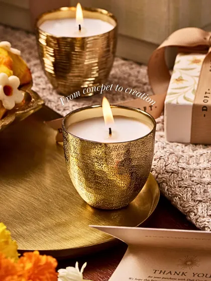 Every candle tells a story. This image, showing the journey from concept to creation, reveals how ancient coins became the muse for my Metallic Votive Candle, transforming their textures into vessels that hold light.