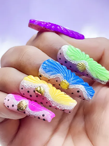 A vibrant and colorful 3D shell effect nail art. This design uses multiple neon colors with polka dots and lace-like details, perfect for a summer look.