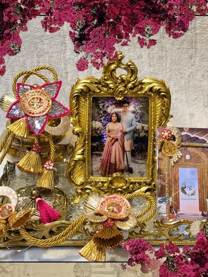 A framed version of the personalized engagement hamper, highlighting the beautiful combination of the couple's photo and the traditional golden decor.