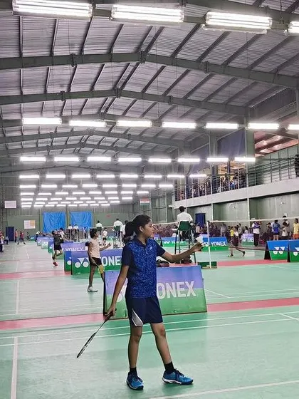 A wide shot of the tournament in progress at our academy, with multiple matches happening under the watchful eyes of umpires and spectators.
