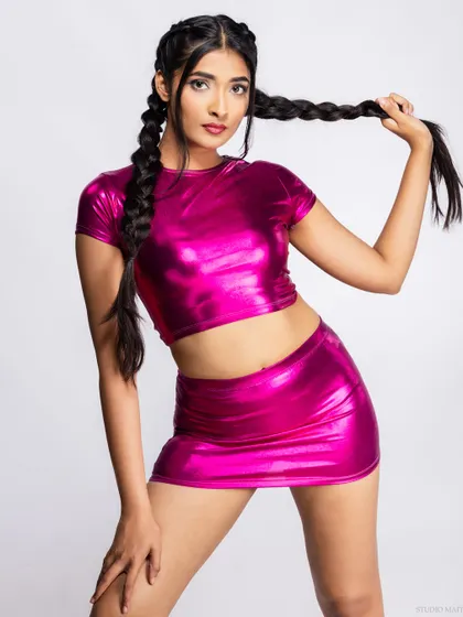 A playful pose with the model holding her braids, showing personality and style.