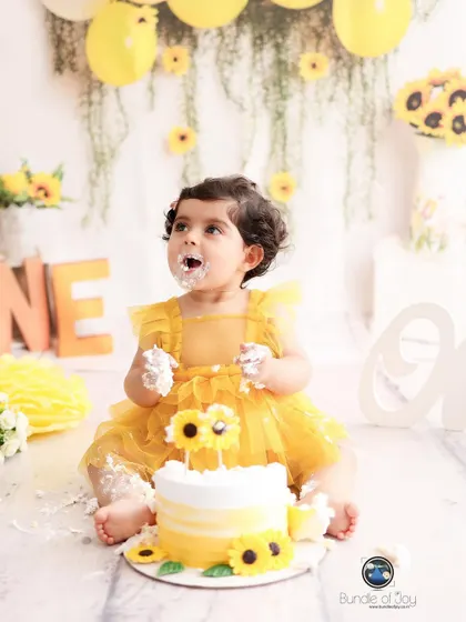 Nothing says "happy first birthday" like a cake smash! This little girl is having the best time with her sunflower themed cake, a perfect example of the pure, unscripted joy I love to capture.