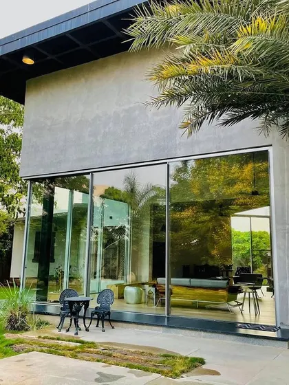 This part of the project focused on creating a seamless indoor-outdoor connection, with a simple lawn and minimalist hardscaping right outside the floor-to-ceiling glass walls.
