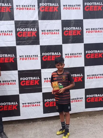 A young player receiving his award at the Independence Cup.