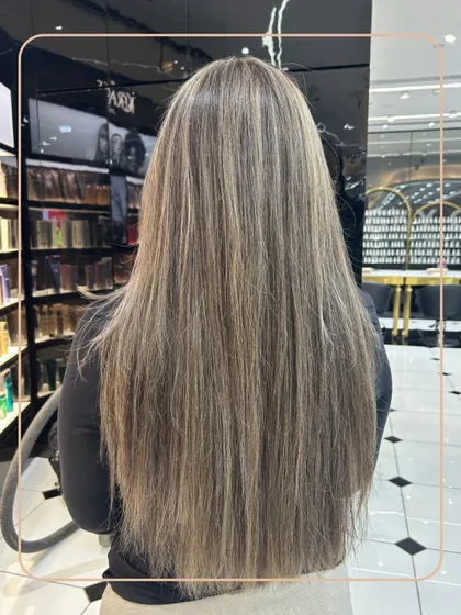 A classic and elegant look featuring fine, ash-blonde highlights on long, straight hair. This technique adds brightness and dimension without being overpowering.