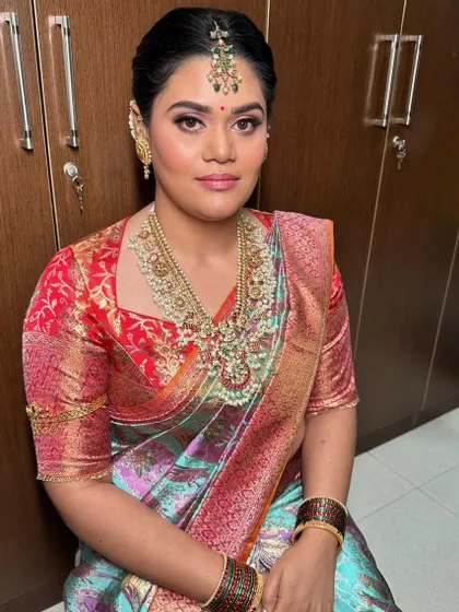 A traditional Pellikuthuru look, with beautifully defined eyes and a colorful silk saree.