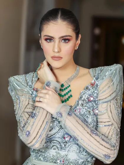 A polished bridal portrait showcasing intricate details in the couture gown and emerald jewelry set. My lighting is set up to capture both the flawless makeup and the sparkle of the accessories.